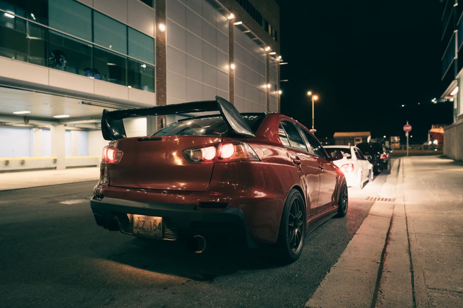 Cars lined up along a city street at night