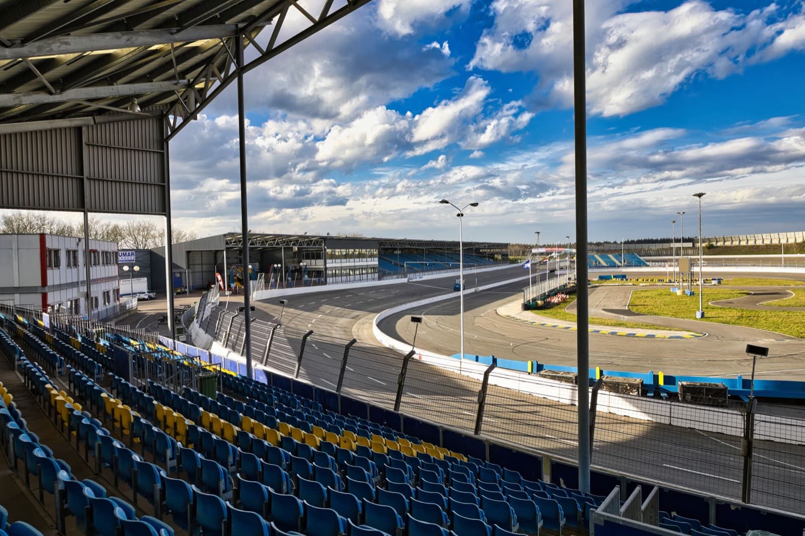 A motorsport circuit and its grandstand under a big sky